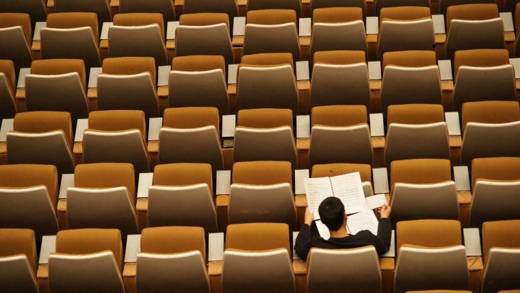 Overhead view of a lecture hall with many empty rows of seats